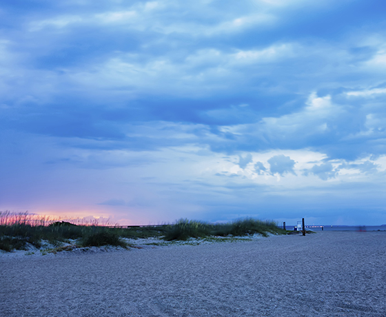 Typbee island beach at sunrise; colors are blues and lavenders